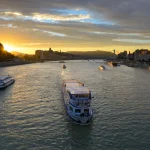 Cruise boat on Danube river at sunset, Budapest
