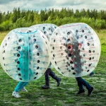 Bumperball. Teens play bumper-ball outdoor