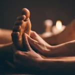 Professional foot massage close up. Authentic shot of luxury spa treatment. Charming light. Shallow depth of field. Stylized and colored.
