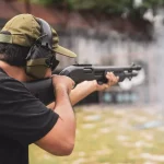 Man shooting on an outdoor shooting range, selective focus