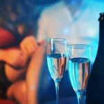 Woman flirting with man in strip club.