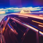 Taxi taking a left turn at night
